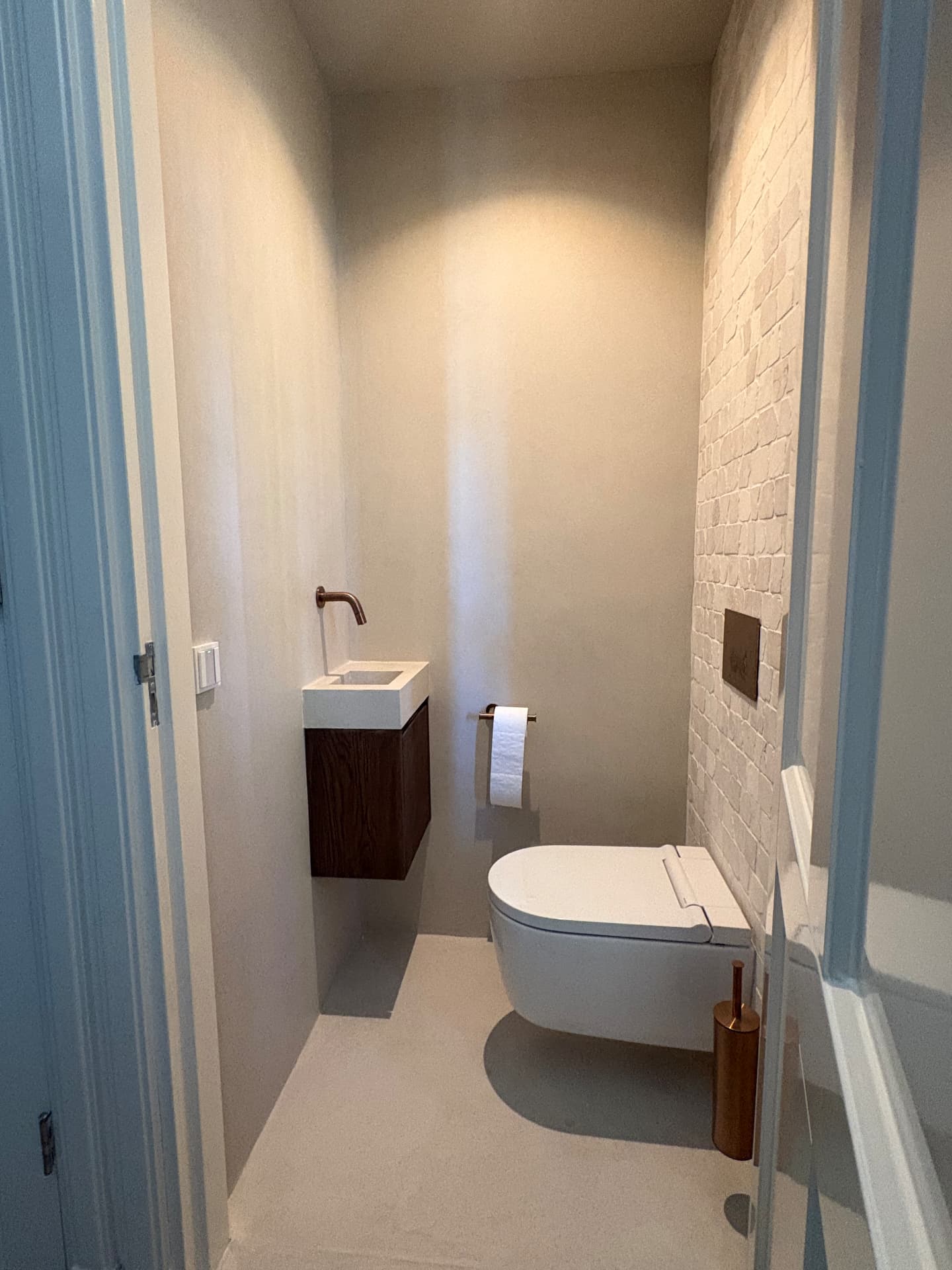 Betonciré wanden in toilet met houten kastje — project in Borne en omgeving